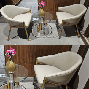 A regal chair with gold legs and a plush beige seat, elegance singal chair .